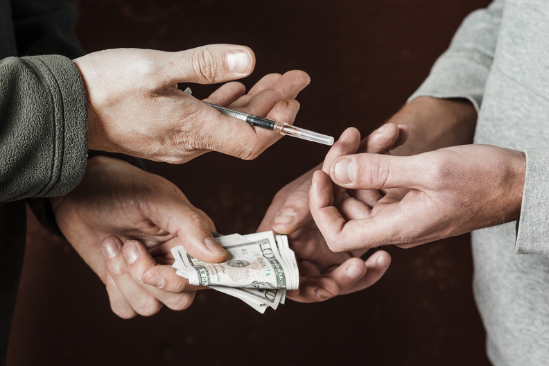 bigstock-Hand-Of-Addict-Man-With-Money--238625833.jpg